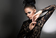 Femininity. Stylized Woman in Black Dress with Bow-knot