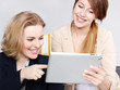 Two business women working with tablet pc in the office