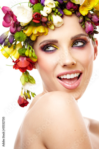 Photo: Woman with hairstyle and freesia flower. Isolated. Woman with hairstyle and freesia flower. Isolated.
