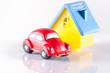 small red toy beetle car and house on white