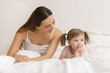 Little girl sulking  with her mother.