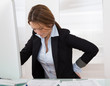 Foto: Businesswoman With Back Pain Businesswoman With Back Pain