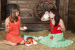 Young girls have lunch on a hayloft
