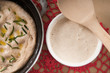 Sourdough in  a white bowl with focaccia bread and doily
