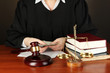 Judge sitting at table during court hearings on black
