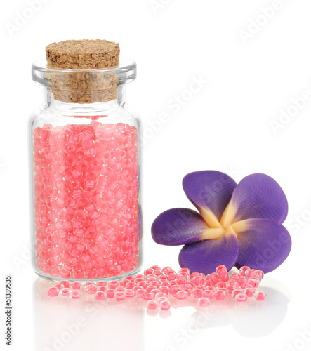 Photo: Little bottle full with colorful beads isolated on white Little bottle full with colorful beads isolated on white