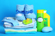 Pile of baby clothes on blue background