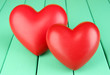 Decorative red hearts on color wooden background