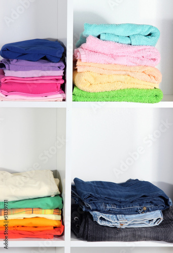 Photo: Clothes neatly folded on shelves Clothes neatly folded on shelves