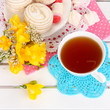 Beautiful composition with cup of tea and marshmallow