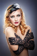Closeup portrait of a topless blonde woman wearing lace gloves