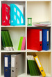 White office shelves with different stationery, close up