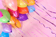 Many bright balloons under ceiling close-up