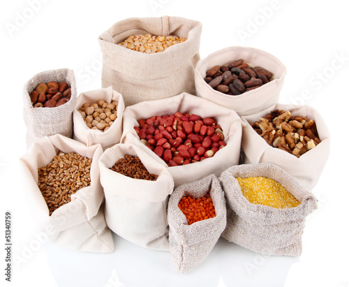 Photo: Different kinds of beans in sacks isolated on white Different kinds of beans in sacks isolated on white