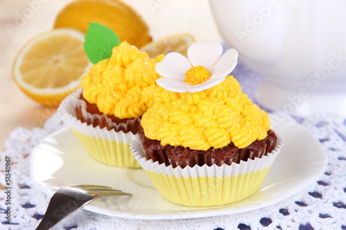 Photo: Beautiful lemon cupcakes on dining table close-up Beautiful lemon cupcakes on dining table close-up