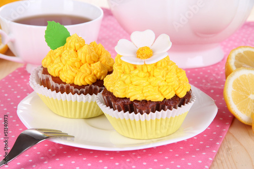 Photo: Beautiful lemon cupcakes on dining table close-up Beautiful lemon cupcakes on dining table close-up