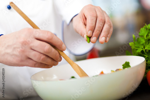 Photo: Chef preparing a salad Chef preparing a salad
