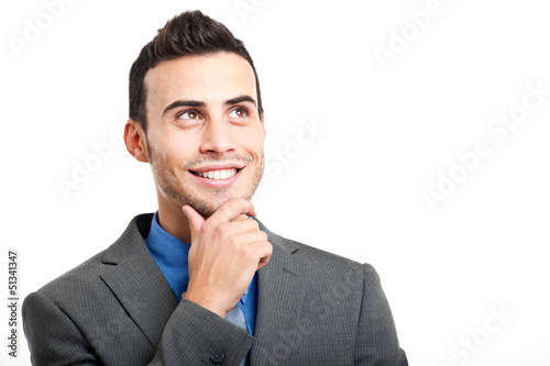 Photo: Smiling businessman looking up Smiling businessman looking up