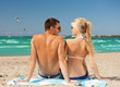 happy couple in sunglasses on the beach