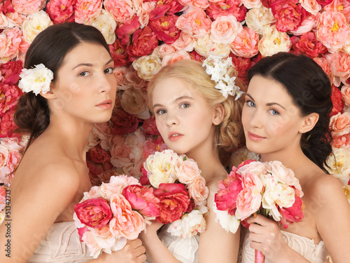 Photo: three women with background full of roses three women with background full of roses