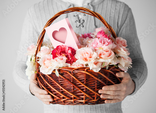 Photo: man holding basket full of flowers and postcard man holding basket full of flowers and postcard