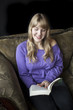 Young Woman with Beautiful Blue Eyes Reading a Book