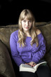 Angry Young Woman with Beautiful Blue Eyes Reading a Book