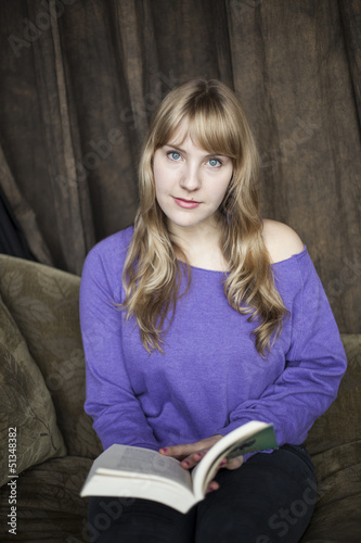 Photo: Young Woman with Beautiful Blue Eyes Reading a Book Young Woman with Beautiful Blue Eyes Reading a Book
