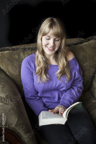 Photo: Young Woman with Beautiful Blue Eyes Reading a Book Young Woman with Beautiful Blue Eyes Reading a Book