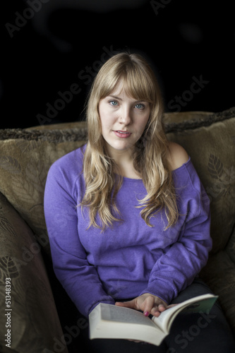 Photo: Young Woman with Beautiful Blue Eyes Reading a Book Young Woman with Beautiful Blue Eyes Reading a Book