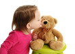 Photo: Little toddler girl kissing a teddy bear Little toddler girl kissing a teddy bear