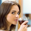 Young woman with glass of redwine