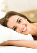 Young woman waking up on bed