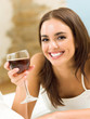 Foto: Young woman with glass of redwine Young woman with glass of redwine