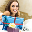 Happy smiling woman with gifts at home