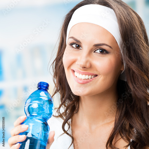 Photo: Woman with bottle of water, at fitness club Woman with bottle of water, at fitness club
