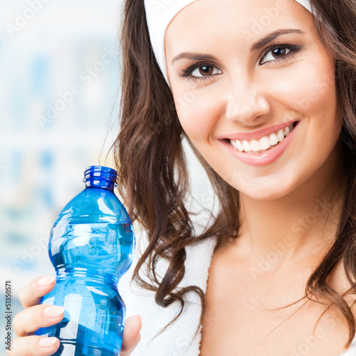 Photo: Woman with bottle of water, at fitness club Woman with bottle of water, at fitness club