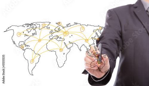 Photo: Businessman drawing a world map isolated on a white background Businessman drawing a world map isolated on a white background