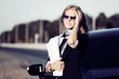 Young businesswoman holding financial papers