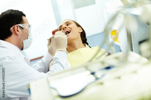 Photo: Examining teeth Examining teeth