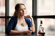 Beautiful young woman with cognac at restaurant