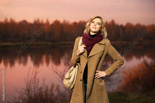 Photo: Young blond woman against an autumn nature background Young blond woman against an autumn nature background