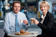Two corporates discussing business over snacks
