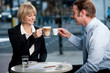 Business partners toasting coffee at cafe