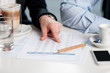 Business people discussing monthly statistics