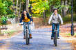 Urban biking - teens riding bikes in city park