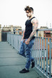 Photo: Young tattooed male model posing on terrace Young tattooed male model posing on terrace