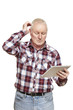 Senior man using tablet computer looking confused