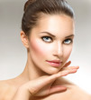 Beauty Portrait. Beautiful Spa Woman Touching her Face