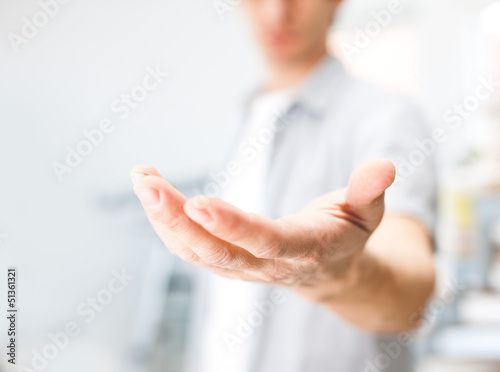 Photo: Man holding something on his hand Man holding something on his hand